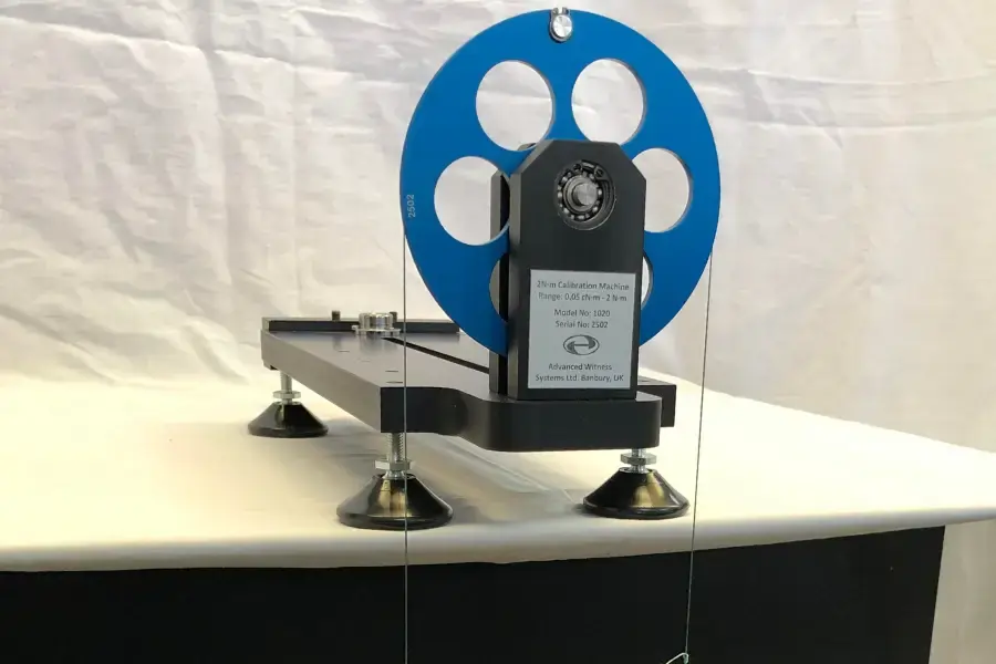 Disc on a torque calibration rig, and suspension cords leading to a weight pan