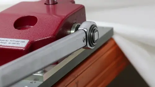 Close up of a torque wrench applying torque to a tester