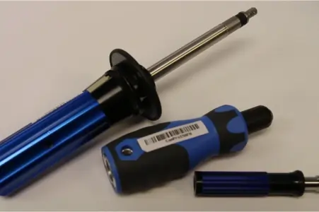 Three blue torque screwdrivers laid on a white table
