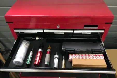Metal storage unit storing several torque screwdrivers within a draw