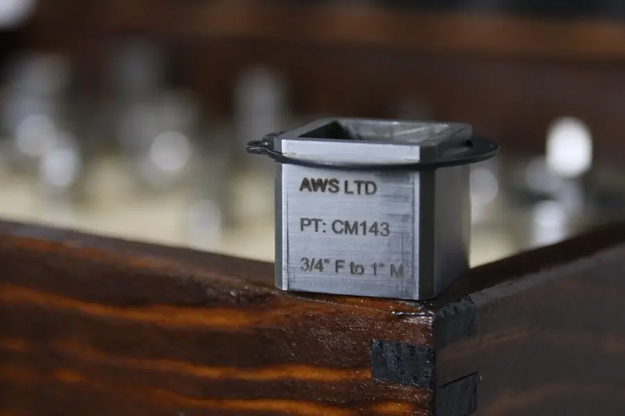 AWS Square to square Precision Torque Adapter sat atop a wooden container with several other adapters inside