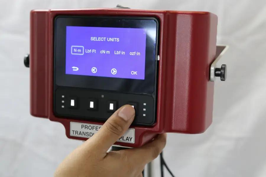 Person operating an AWS torque display to select torque units