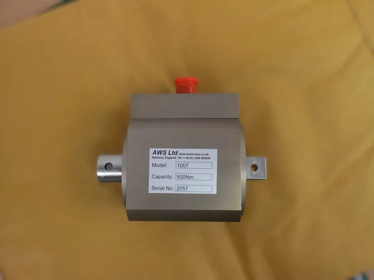 Side on view of rotary transducer with yellow background