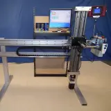 Cropped photo of a torque wrench calibrator in front of a blue background