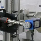 Close up of a torque wrench being calibrated using a torque transducer
