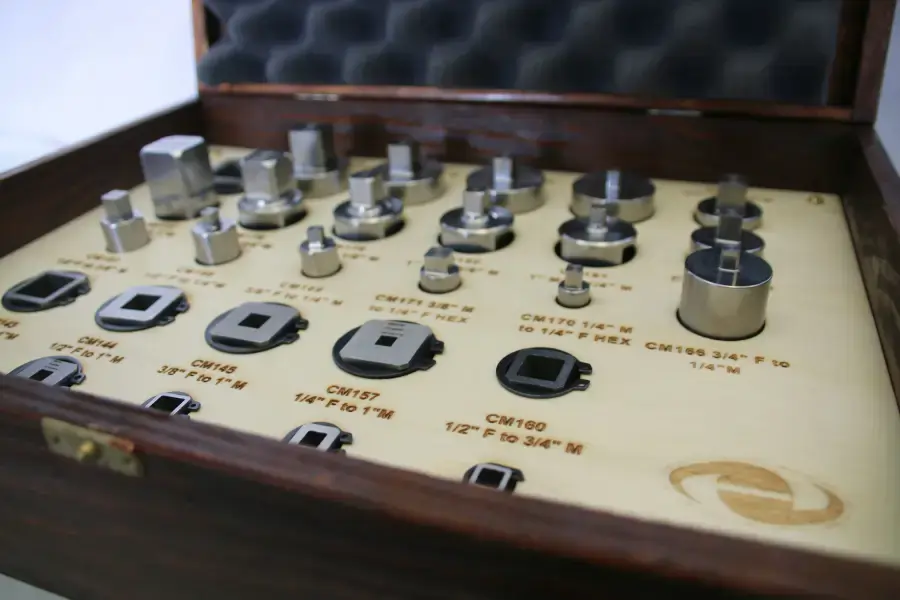 Wooden box containing many precision torque adapters