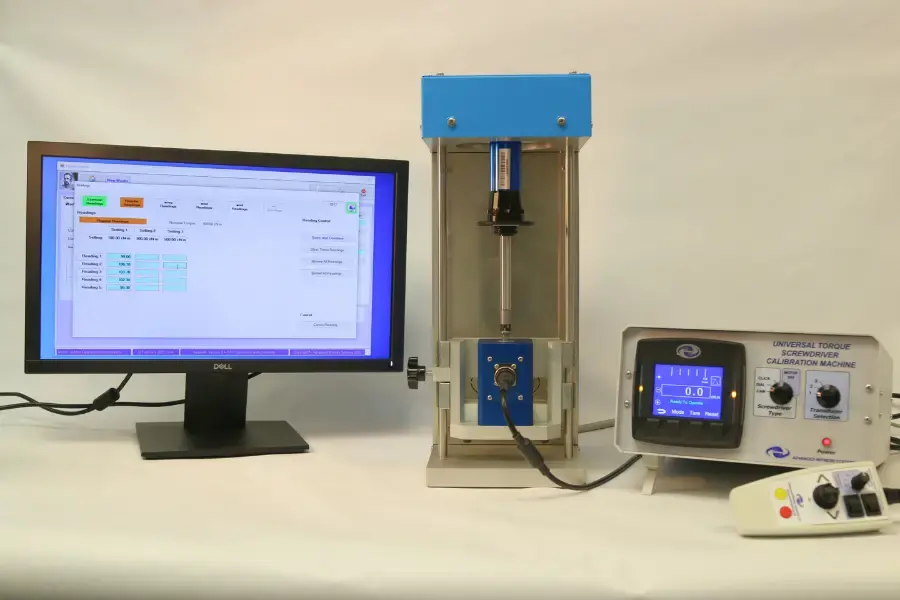 Computer running torque calibration software next to the calibration machine