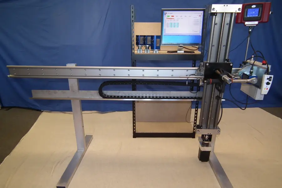 Universal Torque Wrench Calibration Machine in front of Blue Background