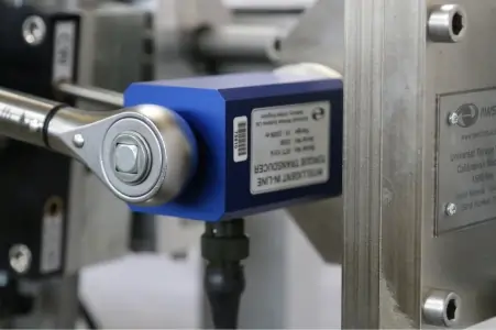 Close up of a torque wrench applying torque to a transducer