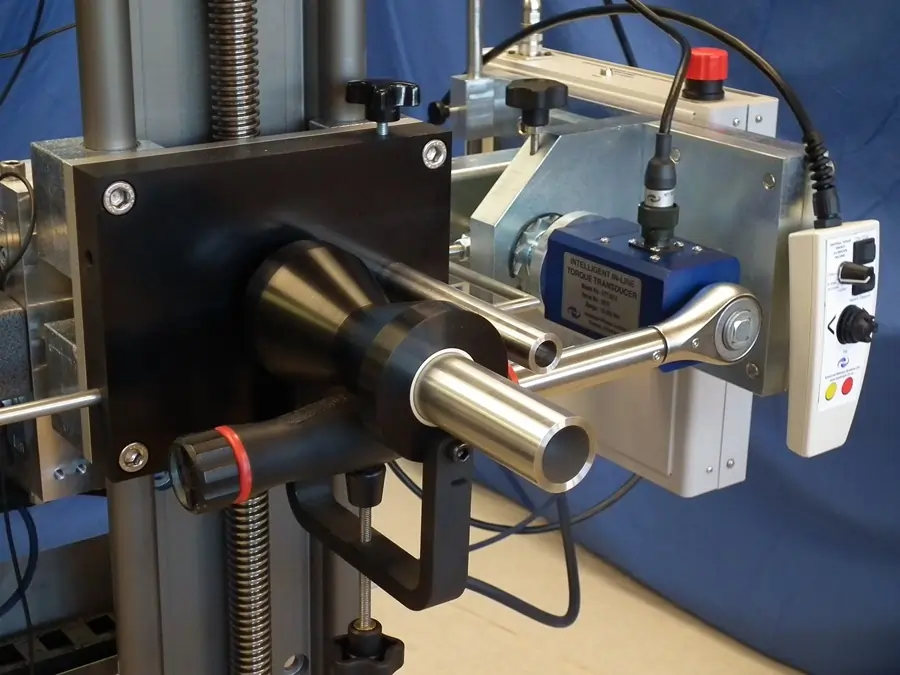Torque wrench calibration on an AWS automated calibration rig in front of a blue background